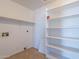 Utility room provides practical storage solutions with built-in shelving and hookups for laundry appliances at 516 E Mesquite Ave, Apache Junction, AZ 85119