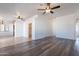 Open-concept living space with wood flooring, white walls, and ceiling fans at 516 E Mesquite Ave, Apache Junction, AZ 85119