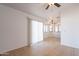 Open-concept living space with tile flooring, white walls, and ceiling fans at 516 E Mesquite Ave, Apache Junction, AZ 85119