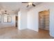 Open-concept living space with tile flooring, white walls, and ceiling fans at 516 E Mesquite Ave, Apache Junction, AZ 85119