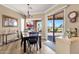 Dining room with a black dining set and views through a sliding glass door to an outdoor patio at 5165 S Peach Willow Ln, Gilbert, AZ 85298