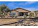 Rear exterior view showcasing the covered patio and landscaped backyard in a serene setting at 5165 S Peach Willow Ln, Gilbert, AZ 85298