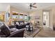 Bright living room with wood-look floors and neutral paint. The room contains two sofas and three large windows at 5165 S Peach Willow Ln, Gilbert, AZ 85298