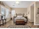 Comfortable main bedroom features wood-look floors, lots of natural light, and a decorative rug at 5165 S Peach Willow Ln, Gilbert, AZ 85298