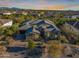 Aerial view showcasing a house with a desert landscape, paver driveway, and tile roof at 5421 E Juniper Canyon Dr, Cave Creek, AZ 85331