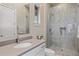 Bathroom featuring a walk-in shower with window, grey countertop, and large mirror in a relaxing atmosphere at 5421 E Juniper Canyon Dr, Cave Creek, AZ 85331