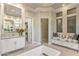 Bathroom with a soaking tub, a vanity, and a bench seat next to a frosted window and the doorway to a closet at 5421 E Juniper Canyon Dr, Cave Creek, AZ 85331