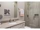 Modern bathroom featuring a glass-enclosed shower, stone countertop, and decorative artwork at 5421 E Juniper Canyon Dr, Cave Creek, AZ 85331