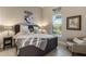 Comfortable bedroom with a tufted headboard, decorative pillows, and natural light from a large window at 5421 E Juniper Canyon Dr, Cave Creek, AZ 85331