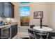 Charming breakfast nook with a modern round table, dark cabinets, and a bright window view at 5421 E Juniper Canyon Dr, Cave Creek, AZ 85331