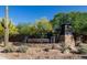 Elegant stone community sign reading 'Bellissima' amidst desert landscape, tall Saguaro cactus and clear blue sky at 5421 E Juniper Canyon Dr, Cave Creek, AZ 85331