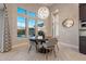 Bright dining area features a stylish chandelier, large windows, and a casual atmosphere at 5421 E Juniper Canyon Dr, Cave Creek, AZ 85331