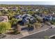 Stunning aerial view of custom home with stone accents, tiled roof, mature landscaping, and mountain views at 5421 E Juniper Canyon Dr, Cave Creek, AZ 85331