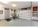 Large garage interior featuring workout equipment, Ferrari decor, and ample storage space at 5421 E Juniper Canyon Dr, Cave Creek, AZ 85331