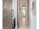 Bright hallway featuring wood floors and decor leading to a bedroom with barn door in a modern home at 5421 E Juniper Canyon Dr, Cave Creek, AZ 85331