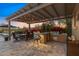 Inviting covered patio with outdoor kitchen, grill, and dining area, perfect for entertaining at sunset at 5421 E Juniper Canyon Dr, Cave Creek, AZ 85331