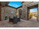 Charming outdoor patio with stone walls, a dining table, and elegant decor perfect for entertaining guests at 5421 E Juniper Canyon Dr, Cave Creek, AZ 85331