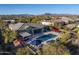 Aerial view of backyard pool with water features and patio, set against a mountain backdrop at 5421 E Juniper Canyon Dr, Cave Creek, AZ 85331