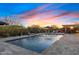 Luxury pool with water features set against a stunning sunset, creating a serene backyard oasis at 5421 E Juniper Canyon Dr, Cave Creek, AZ 85331