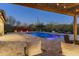 Inviting pool with water features and colorful landscaping, perfect for evening relaxation under a pergola at 5421 E Juniper Canyon Dr, Cave Creek, AZ 85331