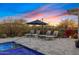 Relaxing poolside lounge area featuring comfortable chairs with sunset views, perfect for unwinding at 5421 E Juniper Canyon Dr, Cave Creek, AZ 85331