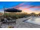 Inviting pool area with comfortable lounge chairs under an umbrella, set against a scenic backdrop at 5421 E Juniper Canyon Dr, Cave Creek, AZ 85331