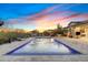 Beautiful backyard features a refreshing swimming pool with fountains under a picturesque sunset sky at 5421 E Juniper Canyon Dr, Cave Creek, AZ 85331