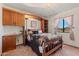 Cozy bedroom with built-in cabinetry, a queen-size bed, and a sunlit window at 5556 E Singletree St, Apache Junction, AZ 85119