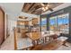 Bright dining area featuring a rustic wood table, bench seating, and views of the desert landscape at 5556 E Singletree St, Apache Junction, AZ 85119