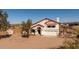 Exterior view of a beautiful two-story house with a spacious yard and a two-car garage at 5556 E Singletree St, Apache Junction, AZ 85119