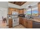 Well-lit kitchen with granite countertops, custom cabinets, and stainless steel appliances at 5556 E Singletree St, Apache Junction, AZ 85119