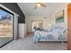 Bright main bedroom featuring a balcony, ceiling fan, dark accent wall, and mirrored closet at 5556 E Singletree St, Apache Junction, AZ 85119