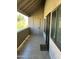 Balcony entrance with sliding glass windows, a security screen door, and outdoor storage area at 5995 N 78Th St # 2026, Scottsdale, AZ 85250