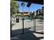 Community pool area with a metal fence, lounge chairs, and palm trees on a sunny day at 5995 N 78Th St # 2026, Scottsdale, AZ 85250