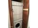 Stacked laundry machines are closeted behind wood-colored doors at 5995 N 78Th St # 2026, Scottsdale, AZ 85250