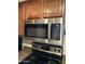 Stainless steel microwave above stovetop with wood cabinets in this kitchen at 5995 N 78Th St # 2026, Scottsdale, AZ 85250