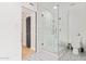 Modern bathroom featuring a glass-enclosed shower with white tile, sleek fixtures, and stylish patterned tile floors at 6012 E Vernon Ave, Scottsdale, AZ 85257