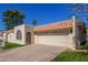 Charming home featuring a tile roof, stucco walls, a two-car garage and well-maintained landscaping at 6012 E Vernon Ave, Scottsdale, AZ 85257