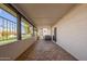 Spacious covered patio with tile flooring, a view of the manicured lawn, and ample outdoor seating at 6012 E Vernon Ave, Scottsdale, AZ 85257