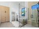 Elegant bathroom featuring a freestanding tub, glass-enclosed shower, and stylish wood cabinetry at 6313 N 10Th Dr, Phoenix, AZ 85013