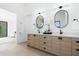 Bathroom featuring a double vanity with oval mirrors and stylish wood cabinetry at 6313 N 10Th Dr, Phoenix, AZ 85013