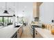 Contemporary kitchen with sleek countertops, stainless steel appliances, and a dining area in the background at 6313 N 10Th Dr, Phoenix, AZ 85013