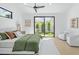 Bright main bedroom featuring a ceiling fan and a large window with backyard view at 6313 N 10Th Dr, Phoenix, AZ 85013