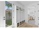 Bright mudroom features built-in shelving, wicker baskets, and views of the beautifully landscaped backyard at 6313 N 10Th Dr, Phoenix, AZ 85013