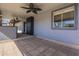 Covered back patio with tiled floors and access to home through a dark paneled door at 6841 W Yucca St, Peoria, AZ 85345