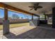 Covered back patio with a lush green lawn and full outdoor kitchen for entertaining at 6841 W Yucca St, Peoria, AZ 85345