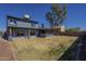 View of the backyard showing the covered patio, trees, and grass at 6841 W Yucca St, Peoria, AZ 85345