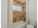 Elegant bathroom features a tub with stone tile surround and rainfall shower head at 6841 W Yucca St, Peoria, AZ 85345