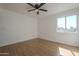 Inviting bedroom with laminate flooring, a window offering natural light, and fresh white walls at 6841 W Yucca St, Peoria, AZ 85345