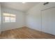 Bright bedroom with laminate floors, a window offering natural light, and ample closet space at 6841 W Yucca St, Peoria, AZ 85345